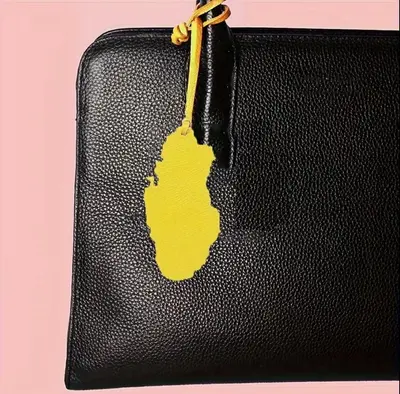 Leather bag tag in the shape of the Qatar map - Yellow